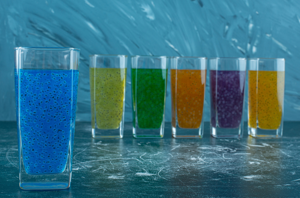 display-juice-glasses-lined-up-blue-background-high-quality-photo